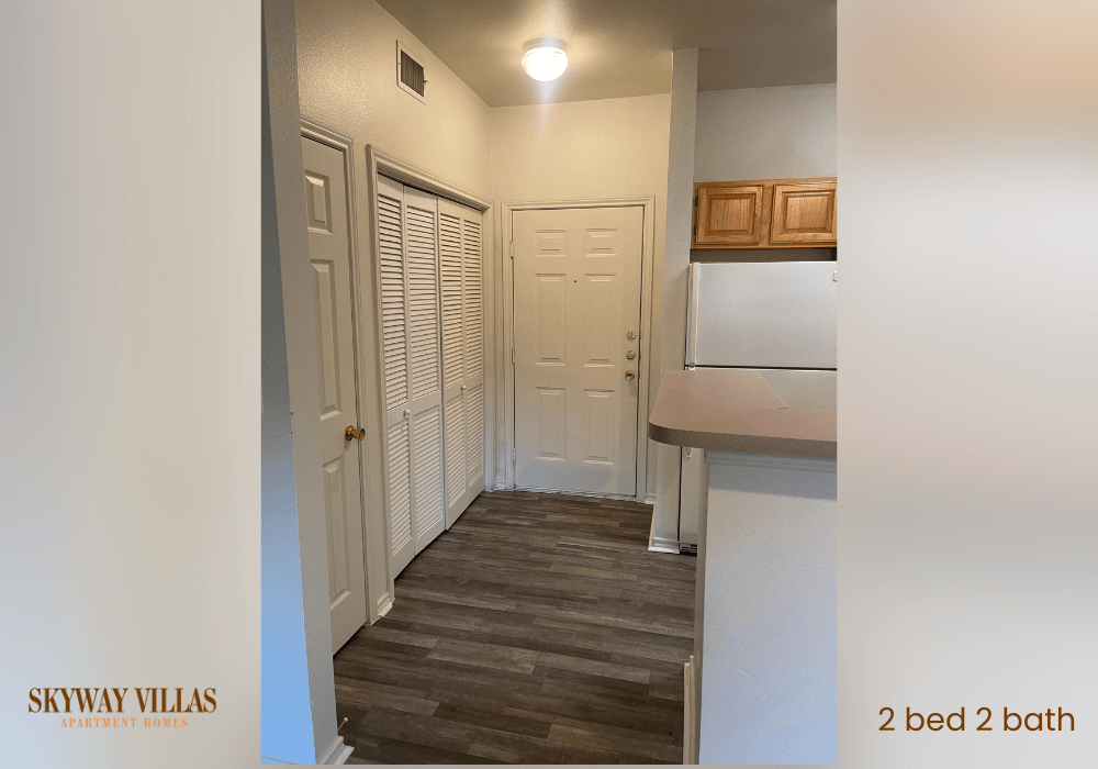 a hallway with a kitchen and a door to a closet
