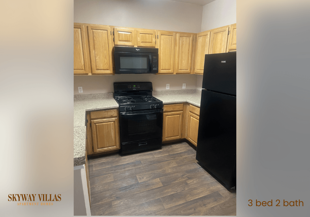 a kitchen with black appliances and wooden cabinets
