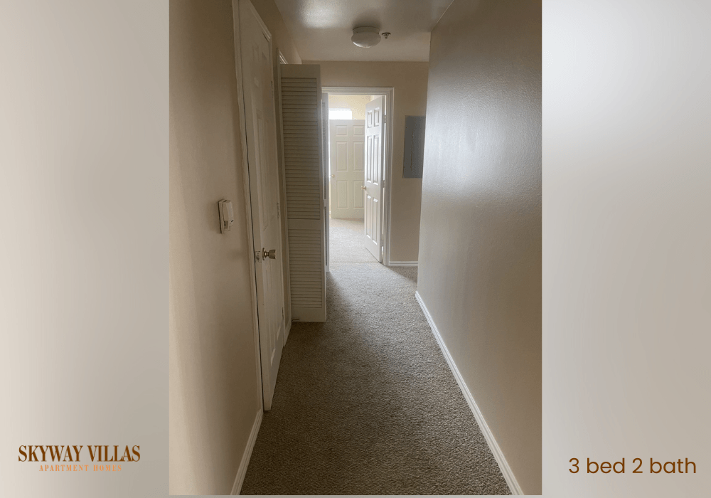 a room with a hallway with a closet and a door to a bathroom