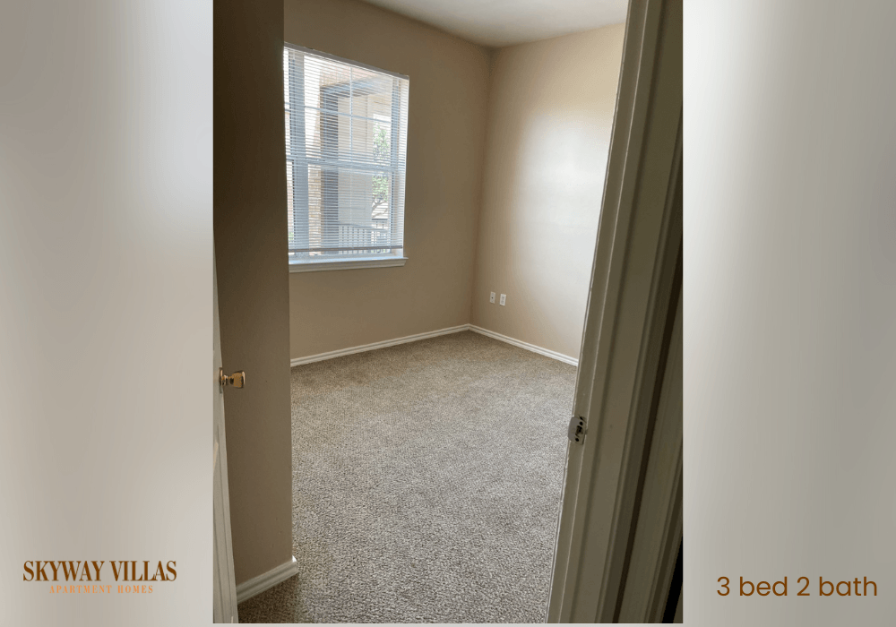 an empty room with a window and a door