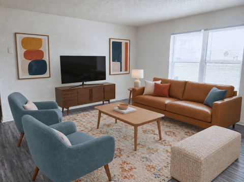 A living room with a brown couch, blue armchair, and a television.