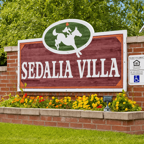 A sign for Sedalia Villa with a horse and rider on it.