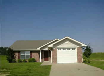 a brick house with a white garage door