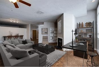 a living room with a gray couch and a black and white rug
