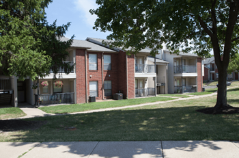 our apartments are located in a quiet neighborhood with trees and grass