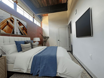 a bedroom with a bed and a tv in a house at The Mill at Prattville, Prattville, AL