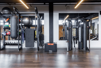 a fitness room with weights and equipment in a gym at The Mill at Prattville, Prattville, AL, 36067