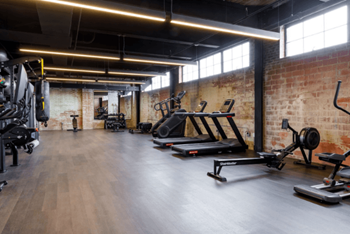 a gym with weights and other exercise equipment at The Mill at Prattville, Prattville, Alabama