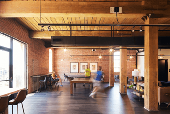 a large room with a ping pong table and people in it at The Mill at Prattville, Alabama, 36067