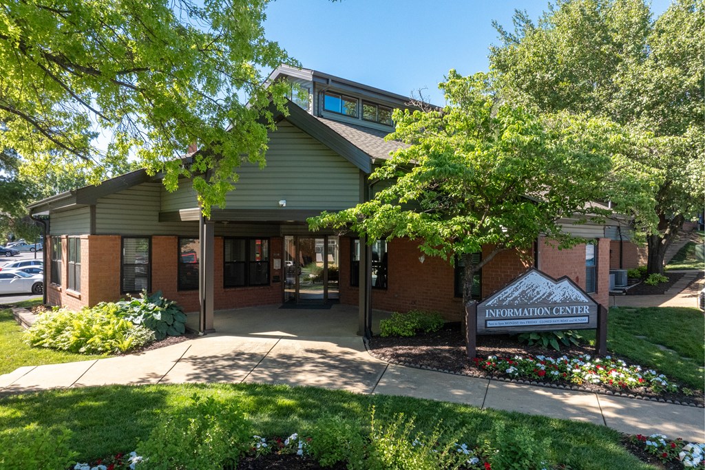 A building with a green roof and a sign that says "Information Center" in front of it.