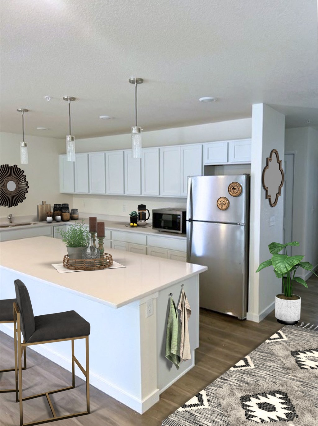 a kitchen with a white counter top and a stainless steel refrigerator