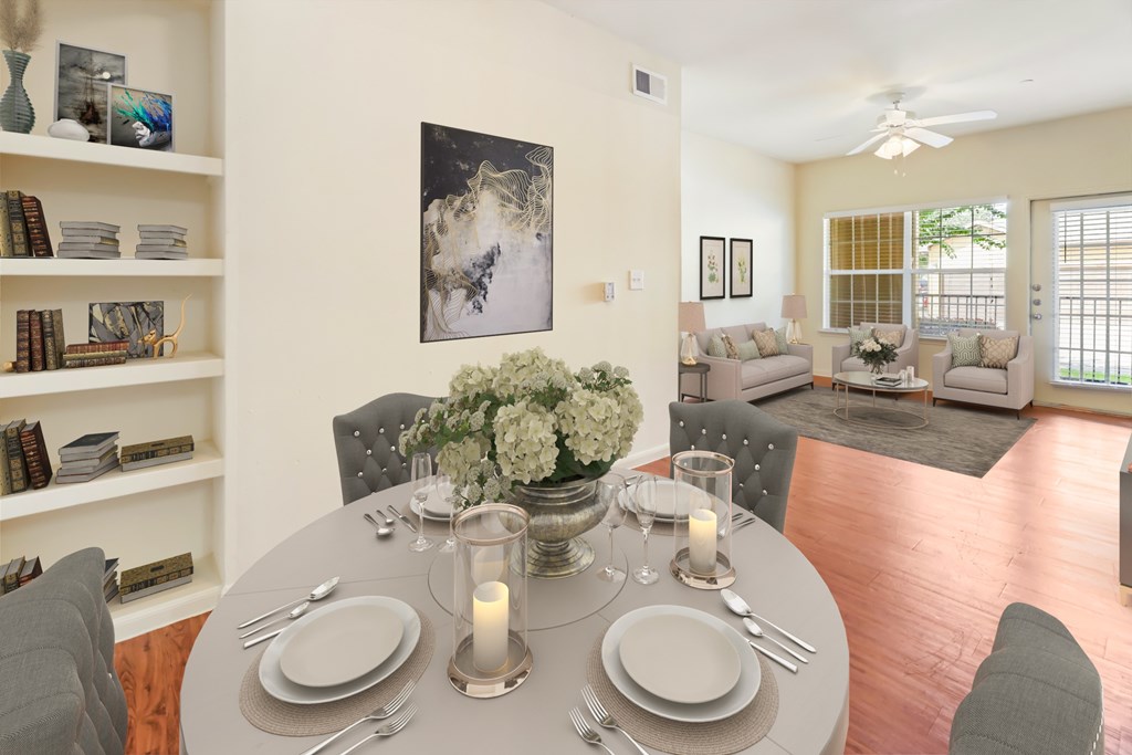 A dining room with a table set for a meal.