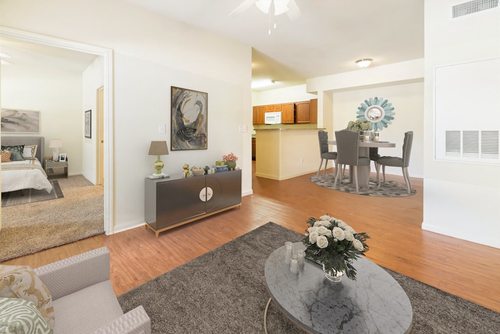 A living room with a grey coffee table and a grey sofa.