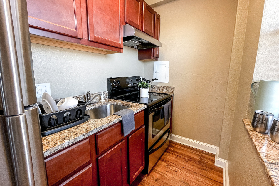 a kitchen with stainless steel appliances and wooden cabinets
