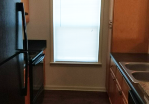 a kitchen with a sink and a window