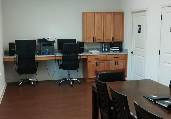 an office with a desk and a table with chairs