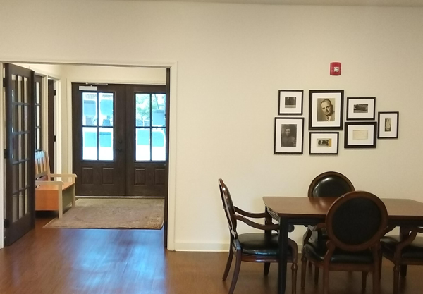 a dining room and living room with a table and chairs