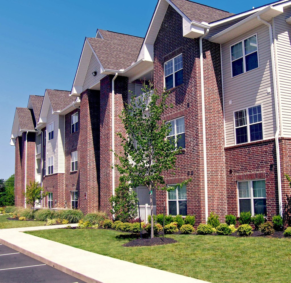 a brick building with a tree in front of it