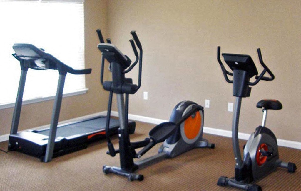 a group of exercise machines in a room