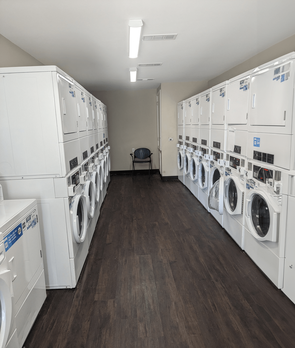 a room full of washers and dryers in a laundry room