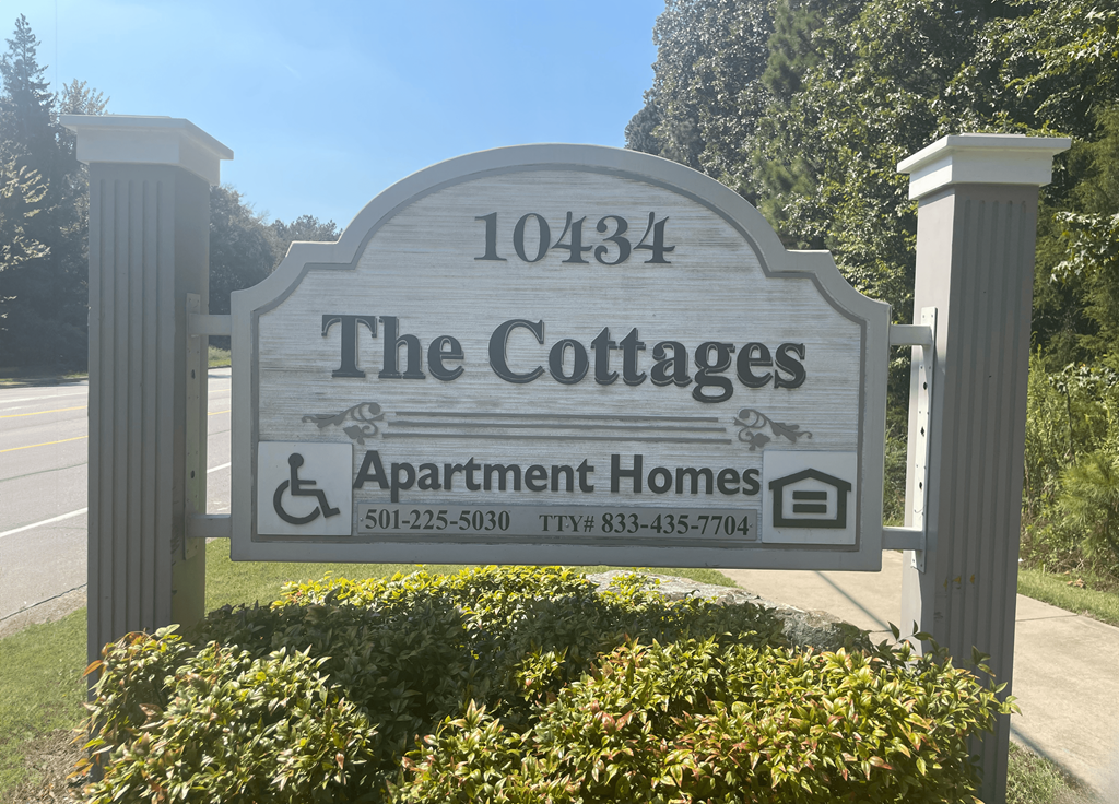 a sign for the cottages apartments and apartment homes