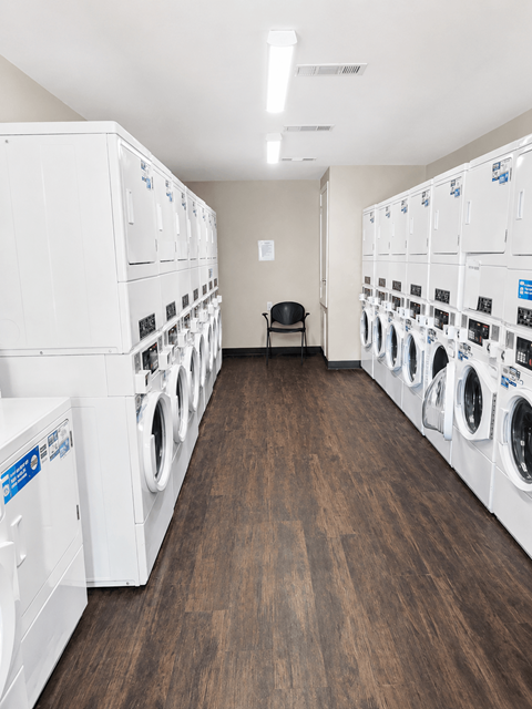 A laundromat with rows of washers and dryers.