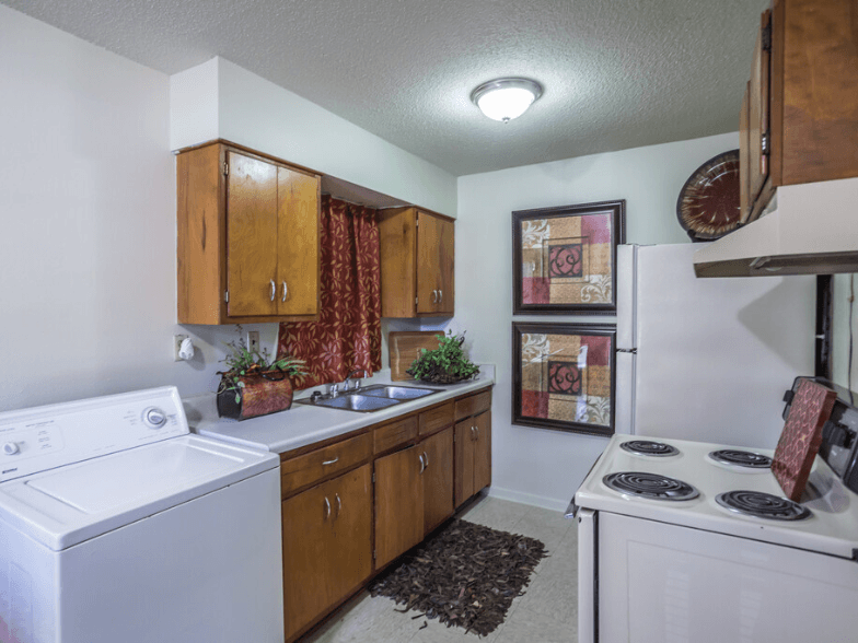 a kitchen with white appliances and wooden cabinets and a white stove