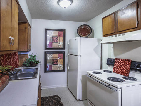 a kitchen with white appliances and a refrigerator