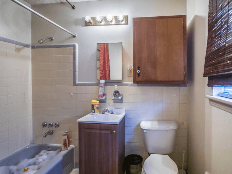 a bathroom with a toilet and a sink and a bath tub