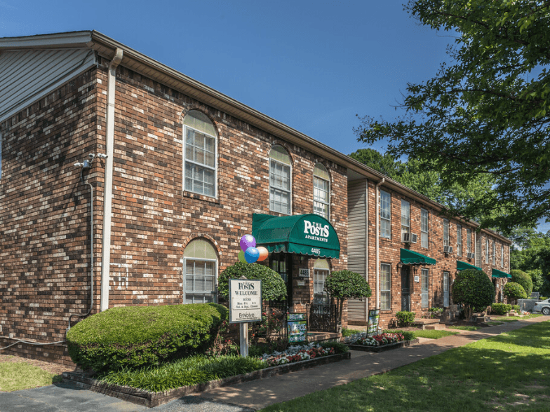 the outside of a brick building with a sign that says roses on it