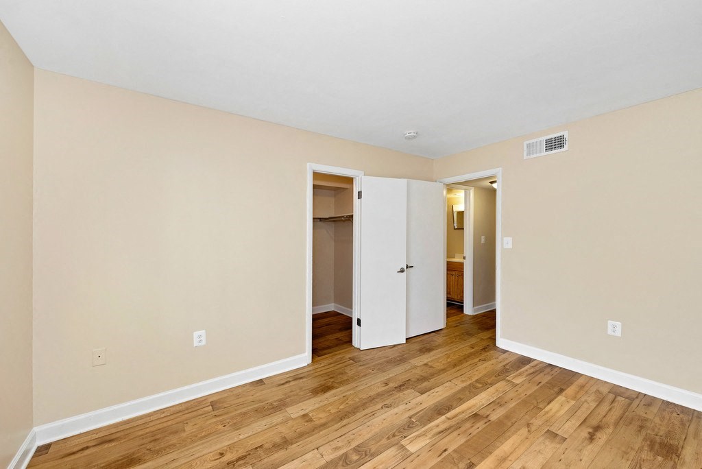 A room with a white door and a white cabinet.