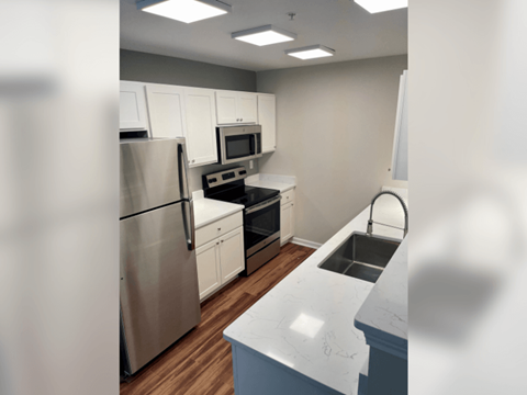 a kitchen with stainless steel appliances and white cabinets