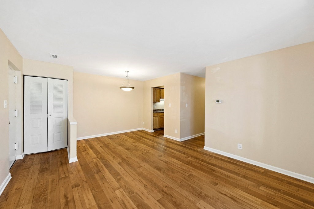 A room with wooden floors and white walls.
