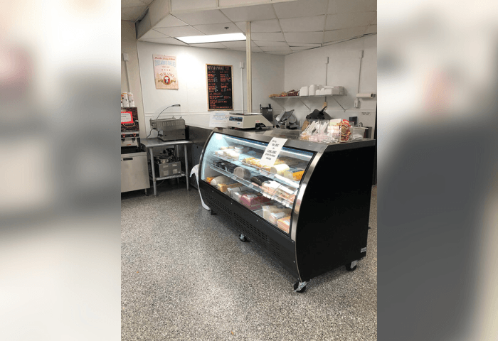 A black and white image of a food display in a restaurant.
