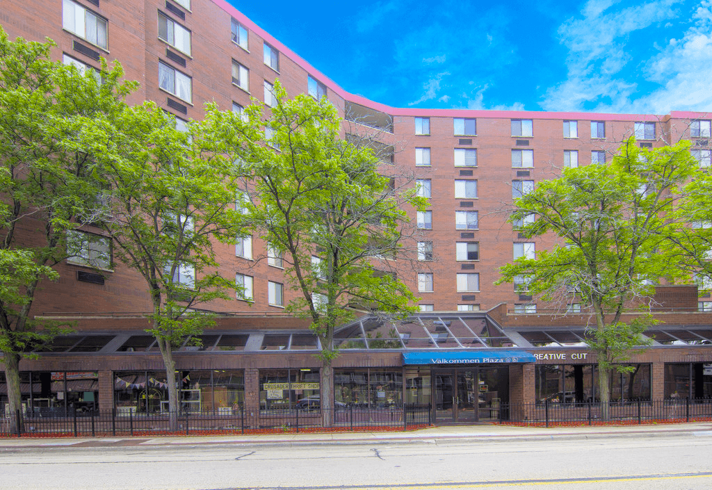 a large brick building with trees in front of it
