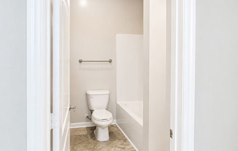 A white toilet in a small bathroom.
