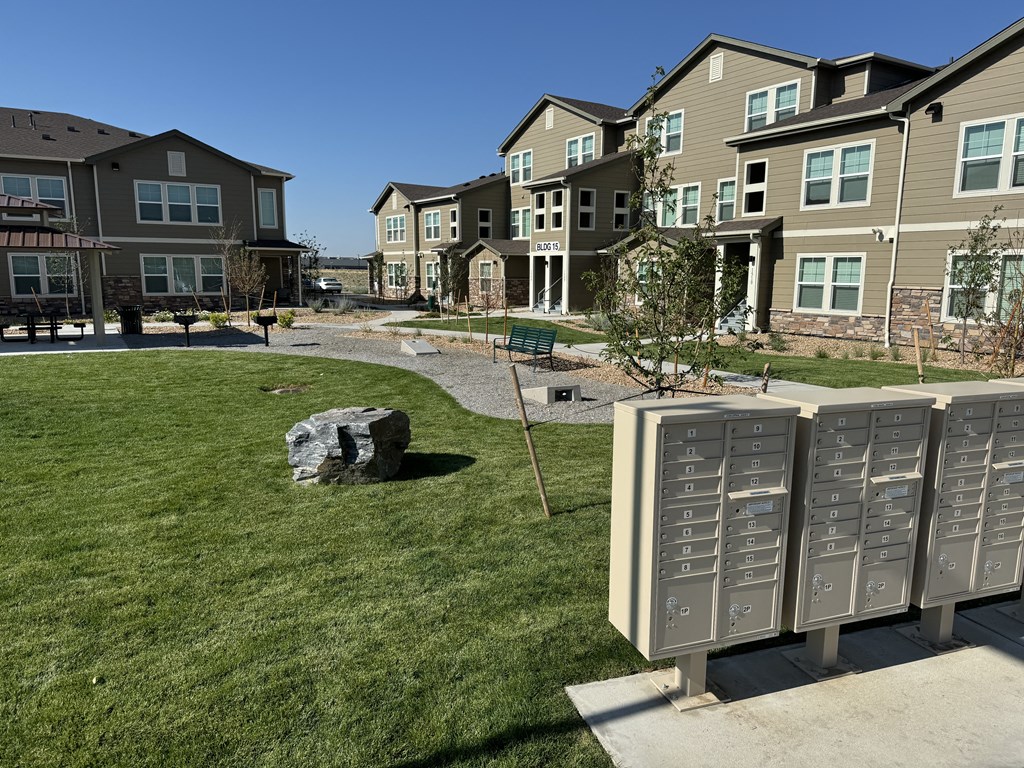 a group of mailboxes in front of an apartment complex
