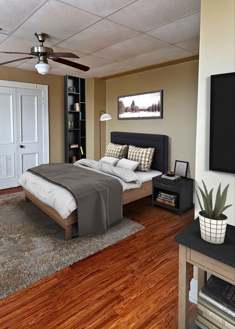 A bedroom with a bed, a nightstand, and a ceiling fan.