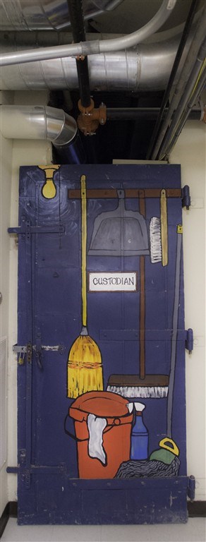A blue door with a sign that says custodian and a broom.