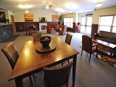 A dining room with a wooden table and chairs.