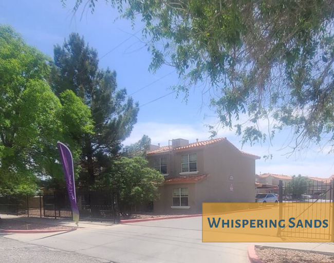 A purple banner with the words "Whispering Sands" on it is in front of a building.