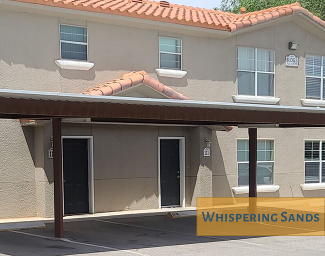 A building with the words Whispering Sands on the front.