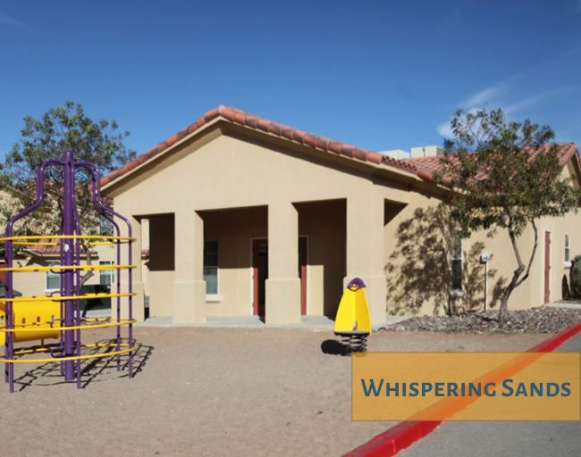 A building with the words Whispering Sands written on it.