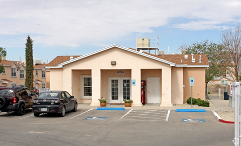 A building with a parking lot in front of it.