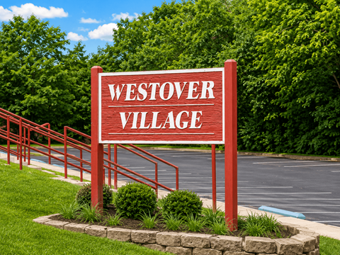 A red sign that says Westover Village in white letters.