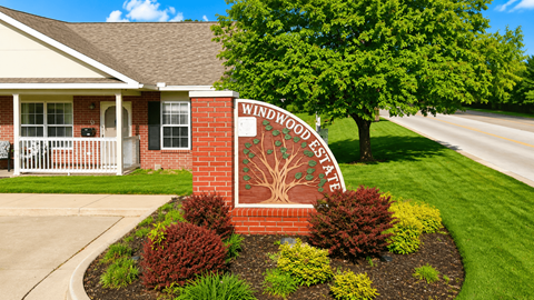 A sign for Woodrow Wilson State is in front of a house.