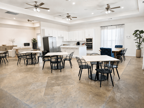 A spacious kitchen and dining area with a table set for six.