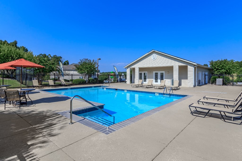 our apartments have a swimming pool with chairs and tables
