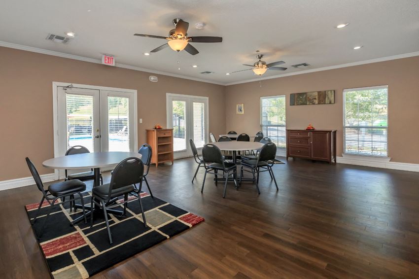 a dining room with a table and chairs and a ceiling fan