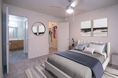 A bedroom with a bed, a dresser, and a mirror.